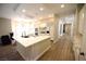 Spacious kitchen with white cabinets, a large island with sink, and wood floors at 2111 Loro Ct, Las Vegas, NV 89117