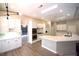 Bright, open kitchen with white cabinets, stainless appliances, and a large marble countertop island at 2111 Loro Ct, Las Vegas, NV 89117