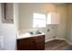Laundry room with marble countertop, wood cabinet, and modern faucet at 2111 Loro Ct, Las Vegas, NV 89117