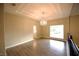 Living room featuring vinyl floors, a chandelier, and a large window at 2111 Loro Ct, Las Vegas, NV 89117
