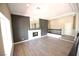 An open living room with a modern fireplace, mirror accent wall, and natural light at 2111 Loro Ct, Las Vegas, NV 89117