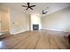 Bright living room featuring hardwood floors, a fireplace and multiple ceiling fans at 2111 Loro Ct, Las Vegas, NV 89117