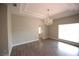 Bright living room with wood floors, tray ceiling and an elegant chandelier at 2111 Loro Ct, Las Vegas, NV 89117