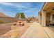 Spacious backyard featuring a stone patio with built-in seating and a covered lounge area at 2217 Merrimack Valley Ave, Henderson, NV 89044