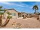 Expansive backyard with desert landscaping, featuring a stone patio and covered seating area at 2217 Merrimack Valley Ave, Henderson, NV 89044
