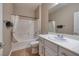 Bright bathroom featuring a shower-tub combo and a single sink vanity with white cabinets at 2217 Merrimack Valley Ave, Henderson, NV 89044