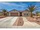 Charming home featuring beautiful desert landscaping, a two-car garage, and a stylish, tiled roof at 2217 Merrimack Valley Ave, Henderson, NV 89044