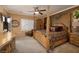 Spacious bedroom with a decorative four-poster bed, dresser, and plush carpeting at 2217 Merrimack Valley Ave, Henderson, NV 89044