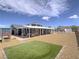 Expansive backyard with a covered patio, artificial turf, and low-maintenance landscaping at 261 W Cypress Dr, Henderson, NV 89015