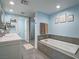 Bathroom boasts a bathtub, shower with glass door, double vanity, and modern fixtures at 261 W Cypress Dr, Henderson, NV 89015