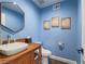Bathroom features vessel sink, wood cabinets, and modern fixtures at 261 W Cypress Dr, Henderson, NV 89015