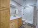 Bright bathroom featuring a sink with a wooden cabinet and a shower with white tile at 261 W Cypress Dr, Henderson, NV 89015