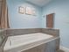 Close-up of the modern bathtub with tile and stylish fixtures at 261 W Cypress Dr, Henderson, NV 89015