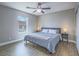Cozy bedroom with natural light, hardwood floors, ceiling fan and comfortable queen-sized bed at 261 W Cypress Dr, Henderson, NV 89015