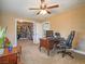 Bedroom area features a ceiling fan, desk, chair, and a glimpse into the expansive walk-in closet at 261 W Cypress Dr, Henderson, NV 89015