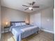 Bedroom with hardwood floors, ceiling fan, natural light and comfortable queen-sized bed at 261 W Cypress Dr, Henderson, NV 89015