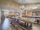 Open floor plan with living and kitchen area with an oversized dining table at 261 W Cypress Dr, Henderson, NV 89015