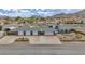 Inviting single-story home with blue siding, four-car garage and mountain views at 261 W Cypress Dr, Henderson, NV 89015