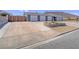 Home exterior with a circular driveway leading to multiple garage doors at 261 W Cypress Dr, Henderson, NV 89015