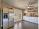 Bright kitchen with white cabinetry and stainless refrigerator leads to backyard patio at 261 W Cypress Dr, Henderson, NV 89015