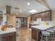 Spacious kitchen features stainless appliances, breakfast bar, and stylish dark wood cabinetry at 261 W Cypress Dr, Henderson, NV 89015