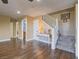 Open-concept living room has hardwood floors, staircase and neutral color palette at 261 W Cypress Dr, Henderson, NV 89015