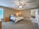 Comfortable main bedroom with neutral tones, ceiling fan, and access to ensuite at 261 W Cypress Dr, Henderson, NV 89015