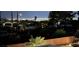 Night view of a well-lit neighborhood overlooking a city skyline with a secure fence at 261 W Cypress Dr, Henderson, NV 89015