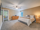 Large main bedroom features neutral paint, carpet, and ceiling fan for comfort at 261 W Cypress Dr, Henderson, NV 89015