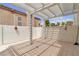 Enclosed outdoor back patio featuring white brick walls and a lattice roof at 2617 Huber Heights Dr, Las Vegas, NV 89128