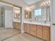 Bathroom featuring double vanity, mirrors, and ample storage space at 2617 Huber Heights Dr, Las Vegas, NV 89128