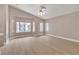 Spacious bedroom featuring a large window, ceiling fan, and light hardwood floors at 2617 Huber Heights Dr, Las Vegas, NV 89128