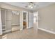 Bright bedroom with hardwood floors, ceiling fan, and closet with mirrored doors at 2617 Huber Heights Dr, Las Vegas, NV 89128