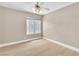Bedroom with light-colored walls, wood-style flooring, and a window overlooking the backyard at 2617 Huber Heights Dr, Las Vegas, NV 89128