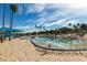Community beach pool with crystal clear water, white sand and palm trees at 2617 Huber Heights Dr, Las Vegas, NV 89128