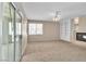 Open living room featuring a fireplace, built-in shelves, and sliding glass doors to the backyard at 2617 Huber Heights Dr, Las Vegas, NV 89128