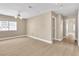 Spacious Living Room featuring hardwood floors, a ceiling fan, and a view to the hall and window at 2617 Huber Heights Dr, Las Vegas, NV 89128