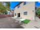 Spacious backyard with gravel, a small patch of artificial turf and a concrete patio area at 2617 Romarin Ter, Henderson, NV 89044