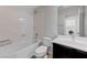 Functional bathroom featuring a tub/shower combo and vanity, laundry in mirror reflection at 2617 Romarin Ter, Henderson, NV 89044