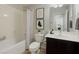 Bathroom with a shower-tub combination, stylish decor, and a sink with dark cabinets at 2617 Romarin Ter, Henderson, NV 89044