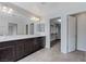 Bathroom showcasing double sinks, large mirrors, great lighting, and large walk in closet at 2617 Romarin Ter, Henderson, NV 89044