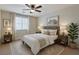 Neutral bedroom with a ceiling fan, decorative art, and coordinated furnishings at 2617 Romarin Ter, Henderson, NV 89044