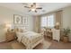 Cozy bedroom decorated with botanical prints, a ceiling fan, and a small study desk at 2617 Romarin Ter, Henderson, NV 89044