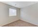 Cozy bedroom with plush carpet, window, and neutral paint at 2617 Romarin Ter, Henderson, NV 89044