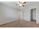 This bedroom offers neutral walls, plush carpeting, and a ceiling fan, providing a tranquil and comfortable space at 2617 Romarin Ter, Henderson, NV 89044