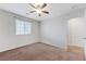 This bedroom features neutral walls, plush carpeting, natural light and a ceiling fan for a cozy, inviting atmosphere at 2617 Romarin Ter, Henderson, NV 89044