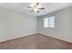 Clean, carpeted bedroom with a ceiling fan and window, offering a blank canvas at 2617 Romarin Ter, Henderson, NV 89044