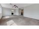 Expansive, carpeted bedroom featuring an en suite bathroom, ceiling fan, and neutral paint at 2617 Romarin Ter, Henderson, NV 89044