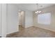 The dining area features tile flooring, a window, and modern lighting at 2617 Romarin Ter, Henderson, NV 89044