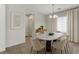 Cozy dining room featuring a modern chandelier, neutral color scheme, and natural lighting at 2617 Romarin Ter, Henderson, NV 89044